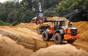 New Loader moving dirt in field,Hitachi Loader moving up with gravel,Loader dropping dirt in truck,Hitachi Wheel Loader moving rocks